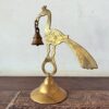 Ornate brass peacock holding the bell decor accent