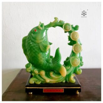 Feng shui Green Carp leaping out of strong current biting on a pearl